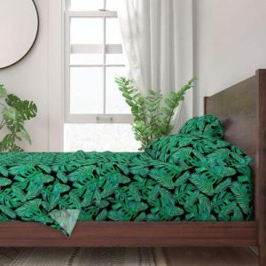 a tropical monstera leaf pattern bed sheet set from spoonflower