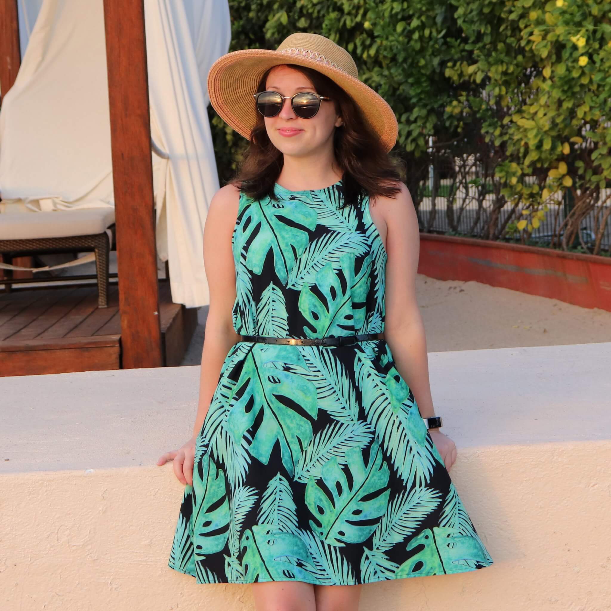 a-line dress paired with a belt, sunglasses and hat
