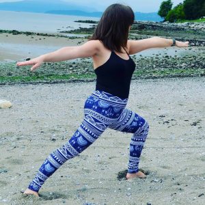 brunette girl yoga pose elephant pattern leggings