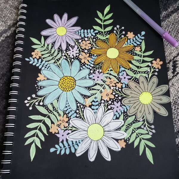 gelly roll pen flower drawing in black paper sketchbook