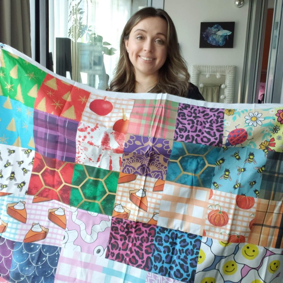 a woman holding a set of fabric swatches from spoonflower
