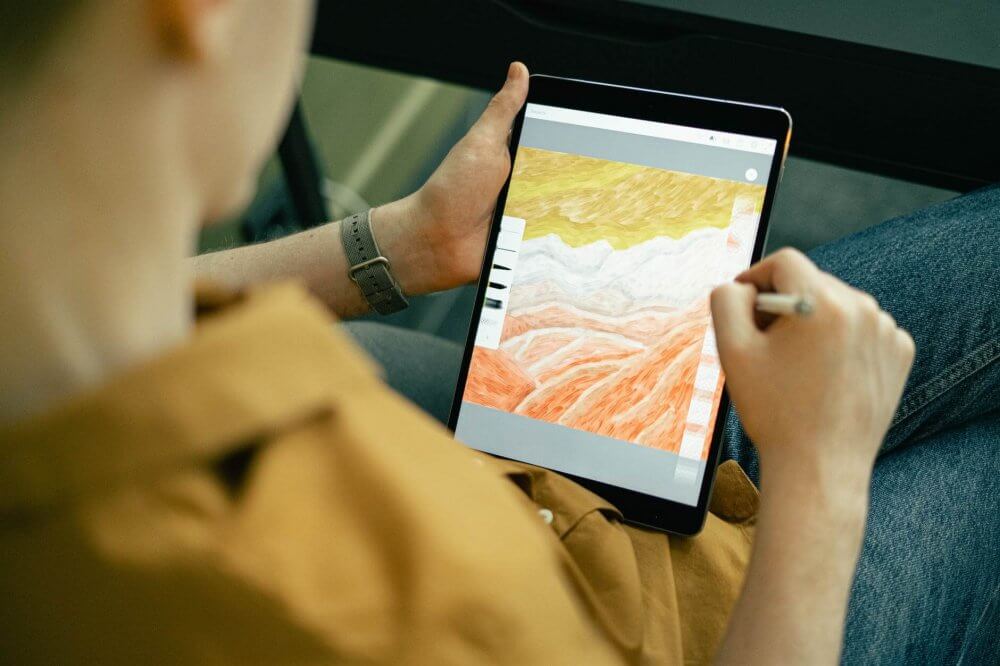an artist drawing on a tablet