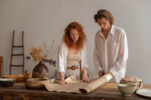 concentrated couple cutting craft paper