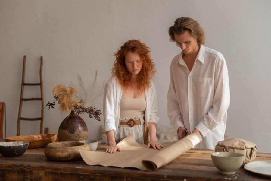 concentrated couple working on their art business plan