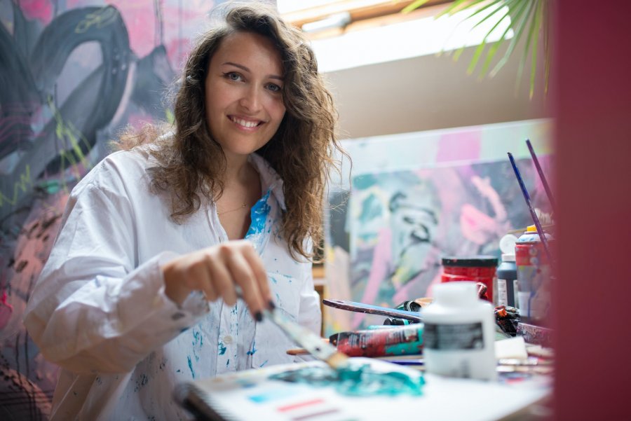 happy woman doing painting