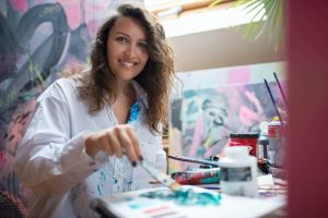 happy woman doing painting