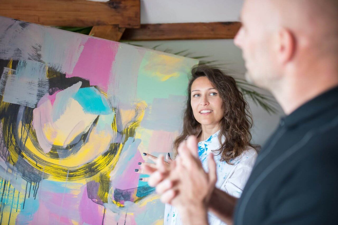 man and woman having a conversation about how to start an art blog