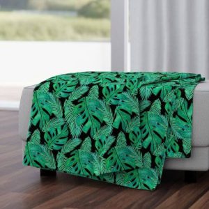 a tropical monstera leaf pattern throw blanket from spoonflower